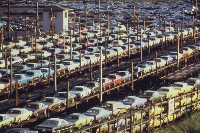 New cars loaded onto railroad cars at Lasher and I-75 in Detroit, in 1973. Photo by Joe Clark. Source: Wikipedia