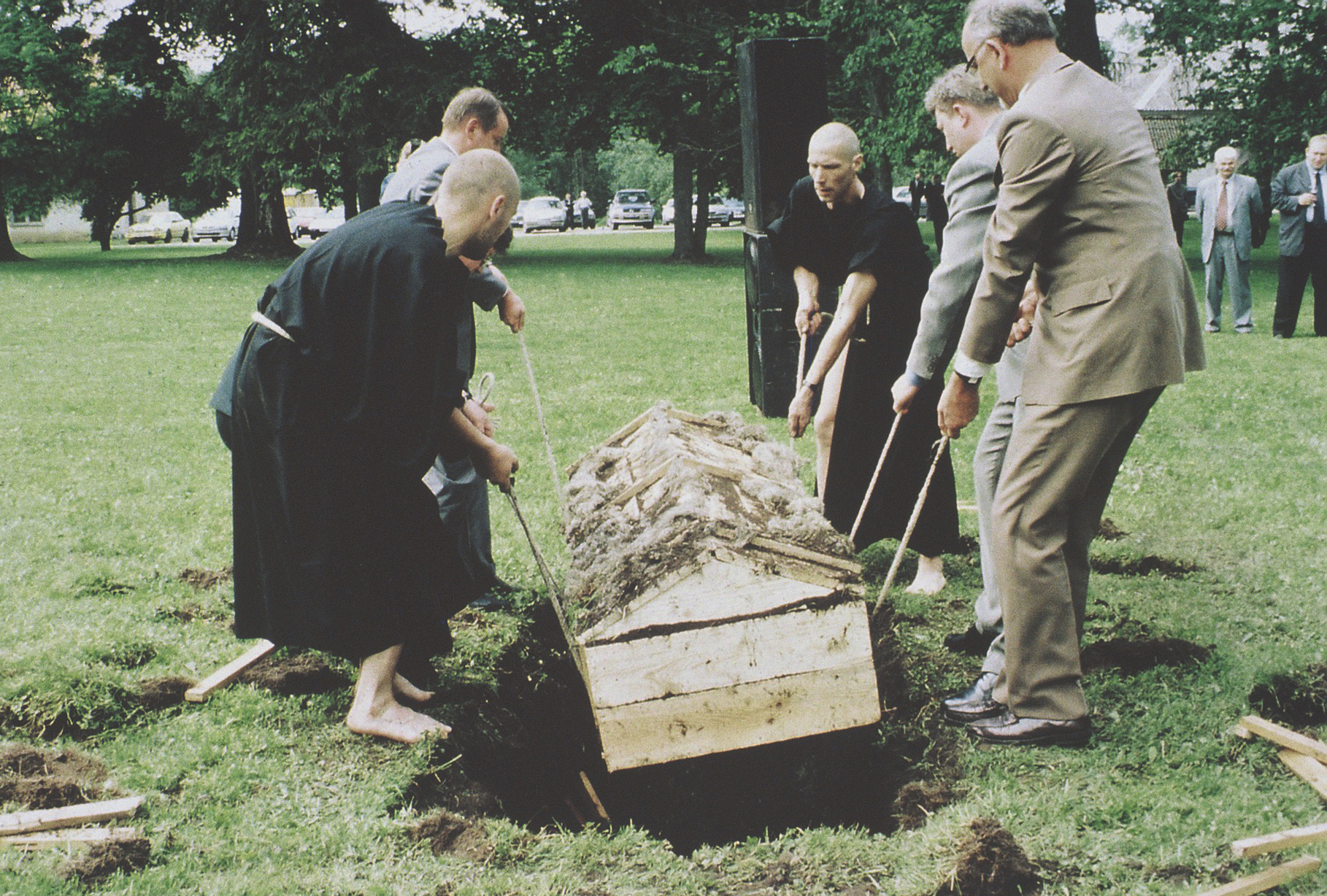 Jaan Toomiku, Raoul Kurvitza & Jaan Paavle performance 19.06.1998 Eesti Pangale kuuluvas Maardu mõisas. Mungarüüsse riietunud kiilaspäised kunstnikud Jaan Toomik ja Raoul Kurvitz kaevavad pargimurusse auku, kuni päevavalgele tuleb kirst. Lahtise haua juurde astuvad kolm Eesti Panga presidenti eri aegadest: Rein Otsason, Siim Kallas ja Vahur Kraft. Koos tõmmatakse kirst välja ja asetatakse katafalgile. Seejärel valatakse kirst üle kergesti süttiva vedelikuga ning peagi on see leekides. Toomik ja Kurvitz hakkavad labidatega kirstu lõhkuma ning sealt kargab leekide vahelt välja ülikonnas ja lipsustatud Jaan Paavle, portfell käes. Fotod: Ingmar Muusikus / Eesti Ekspress